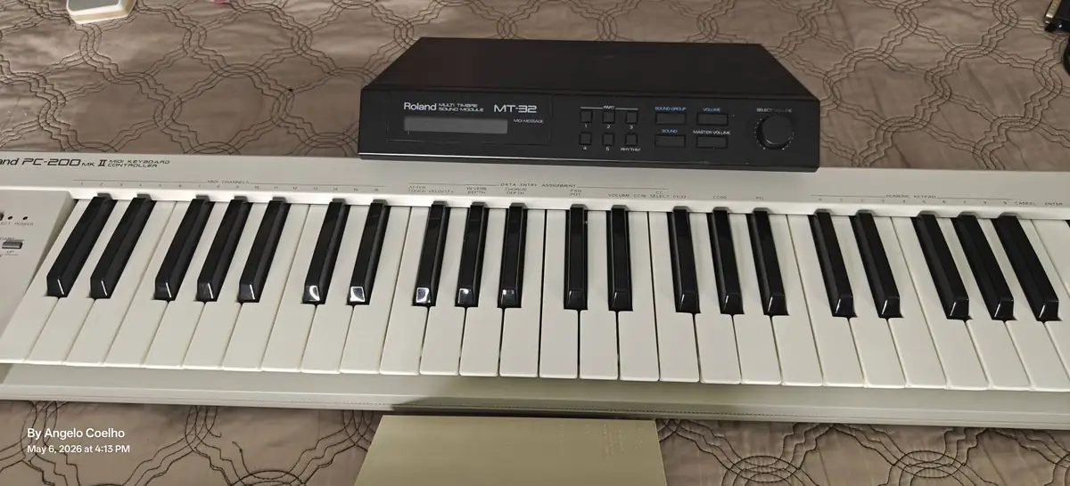 A vintage Roland MT-32 sound module resting on top of an old Roland keyboard, photographed in May 2026
